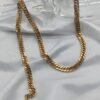 gold plated stainless steel cuban chain necklace on white fabric