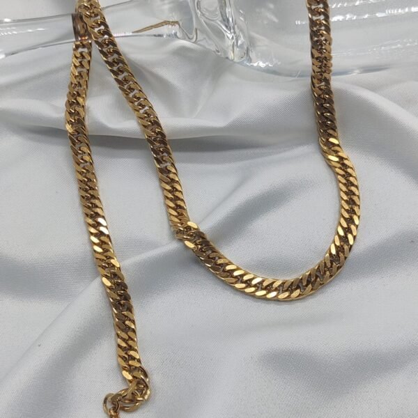 gold plated stainless steel cuban chain necklace on white fabric