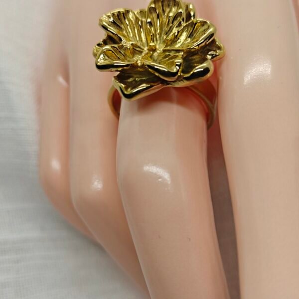 “Magnolia petal-shaped gold-plated stainless steel ring with soft floral design on neutral background”