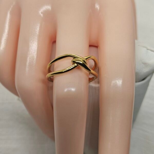 Minimalist stainless steel gold knot ring close-up – Herdise