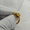 gold plated alligator ring 316l stainless steel on white fabric background