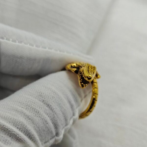 gold plated alligator ring 316l stainless steel on white fabric background