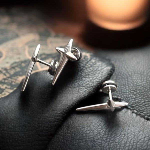 “Stainless steel spike screw-back earrings displayed on black fabric.”