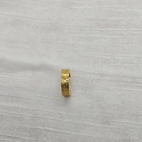 “Three pairs of small stainless steel hoop earrings in gold finish displayed on a white fur surface.”