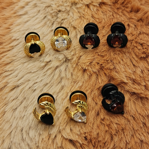 winged heart screw back earrings gold with black stone on far left