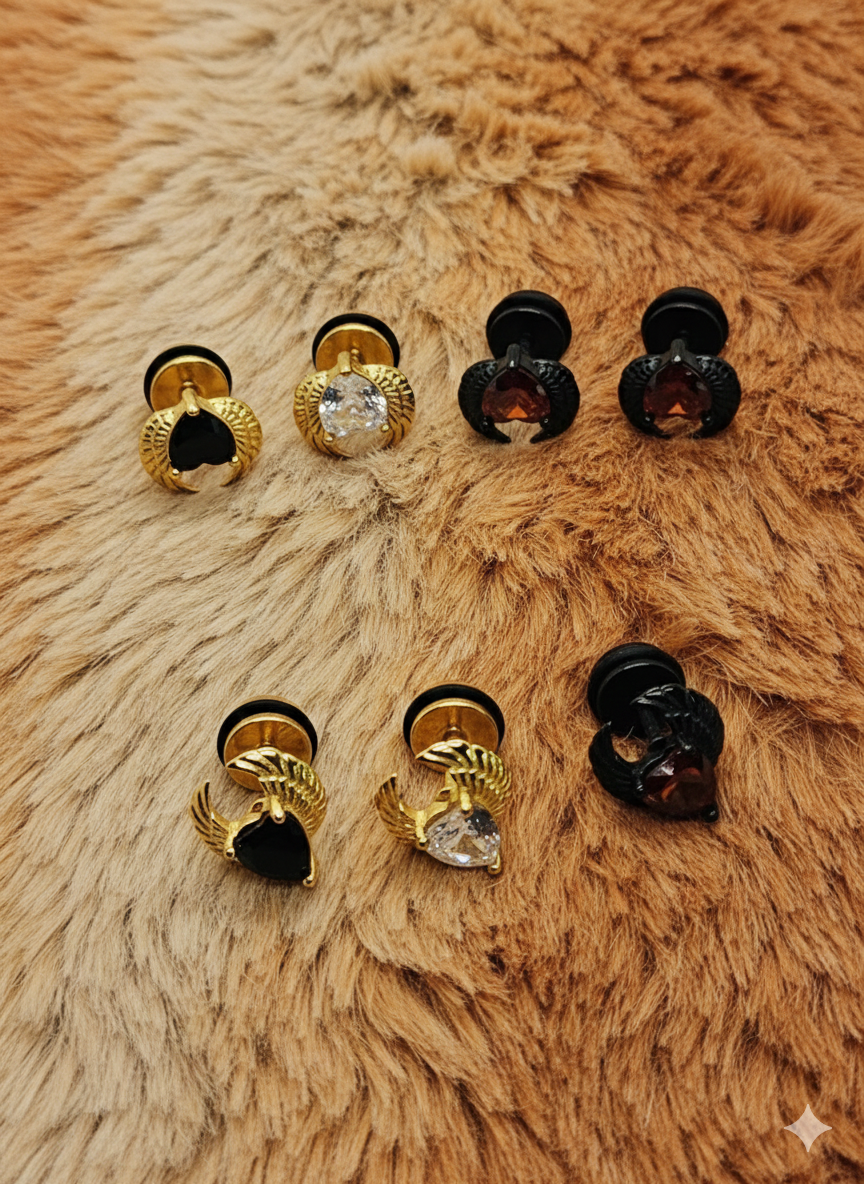 winged heart screw back earrings gold with black stone on far left