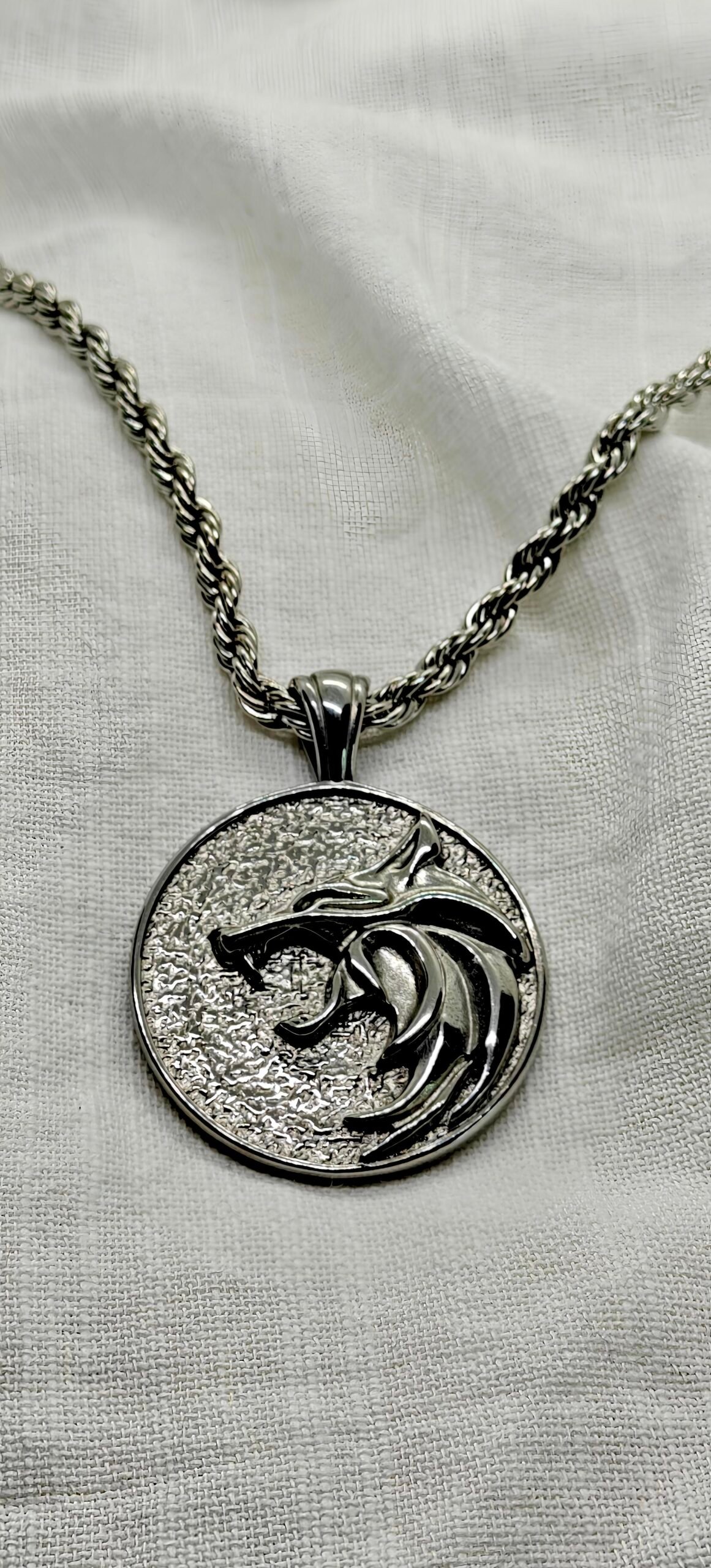 “Wolf head stainless steel pendant necklace with 24" rope chain.”