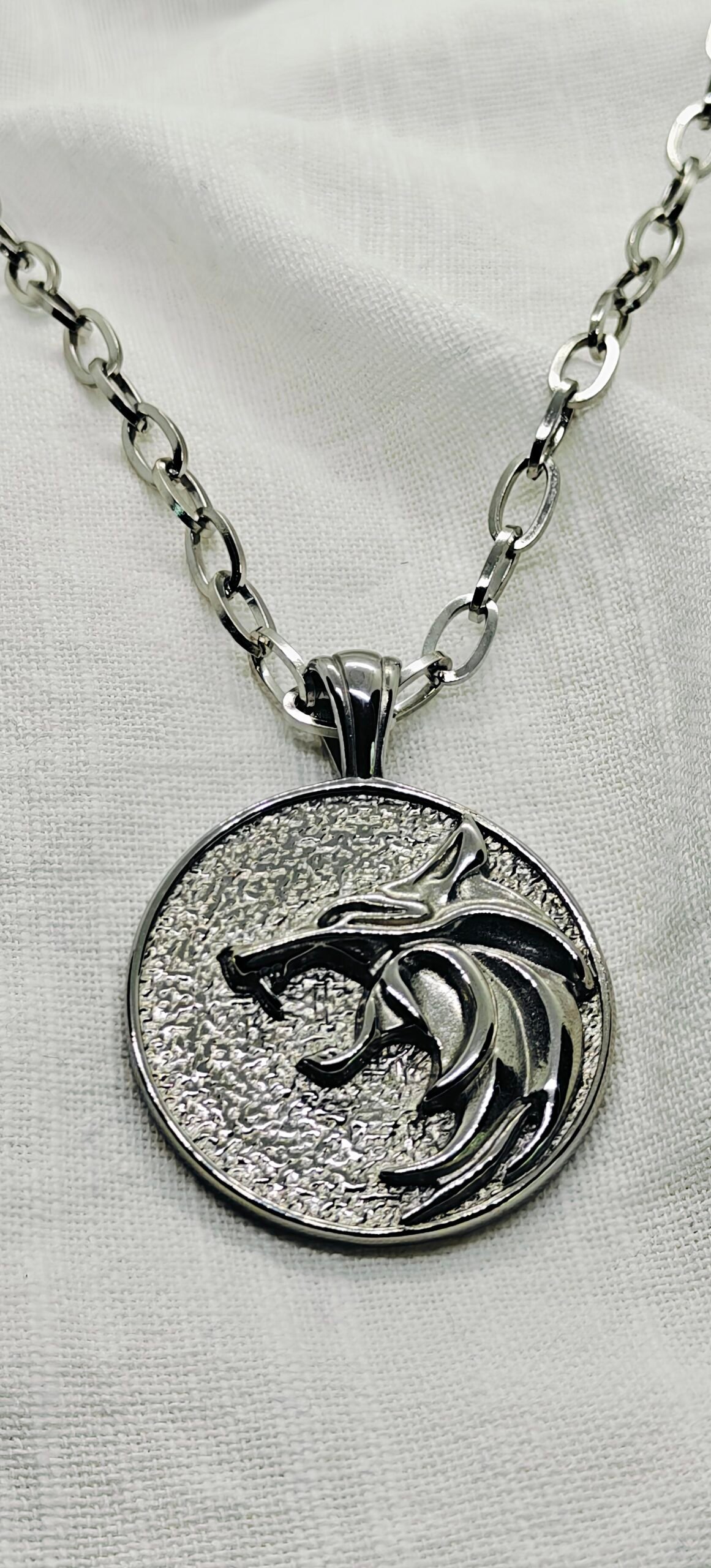 “Wolf head stainless steel pendant necklace with 24"oval chain.”