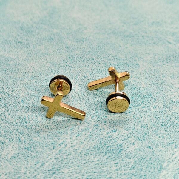 “Latin stainless steel cross screwback stud earring worn on ear.”