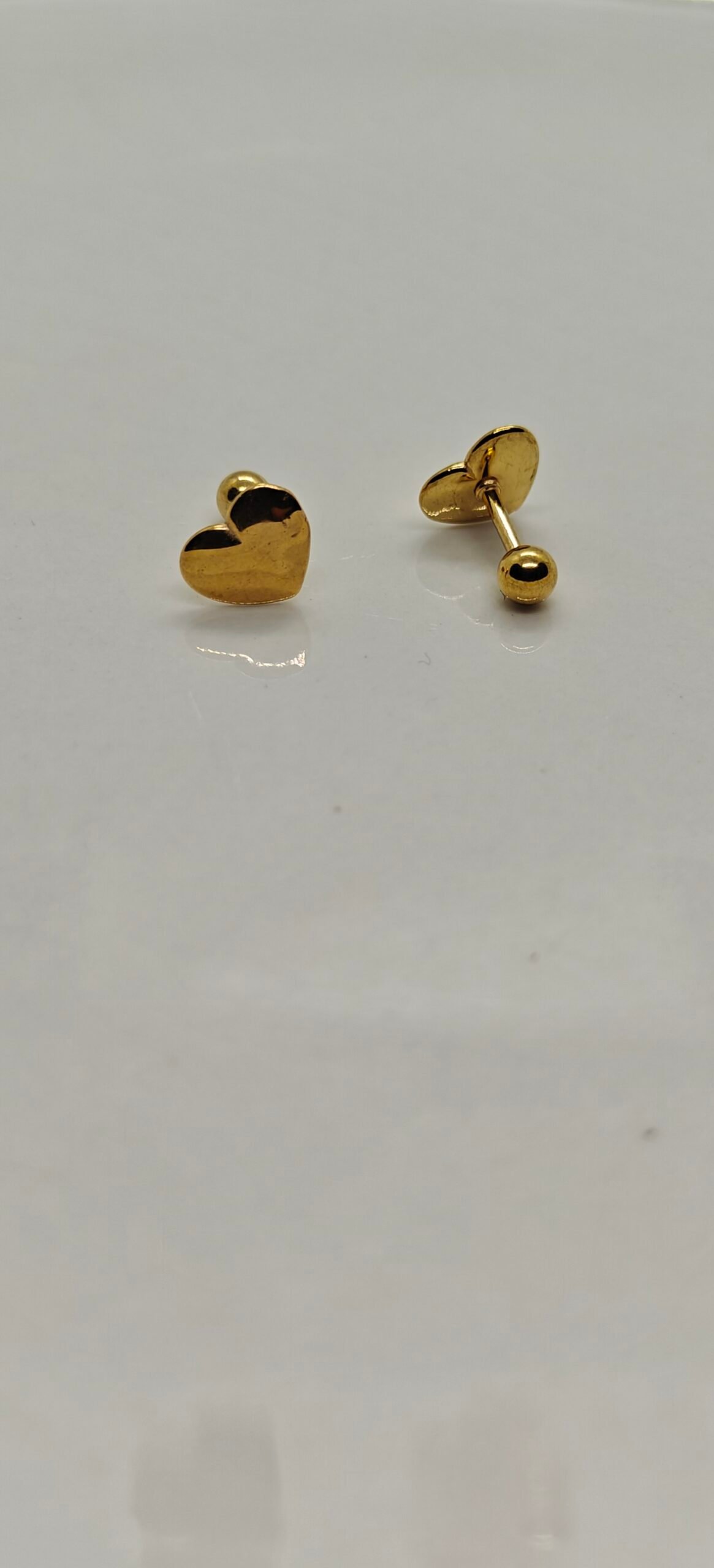 Gold heart screw back stainless steel gold plated earrings on white background
