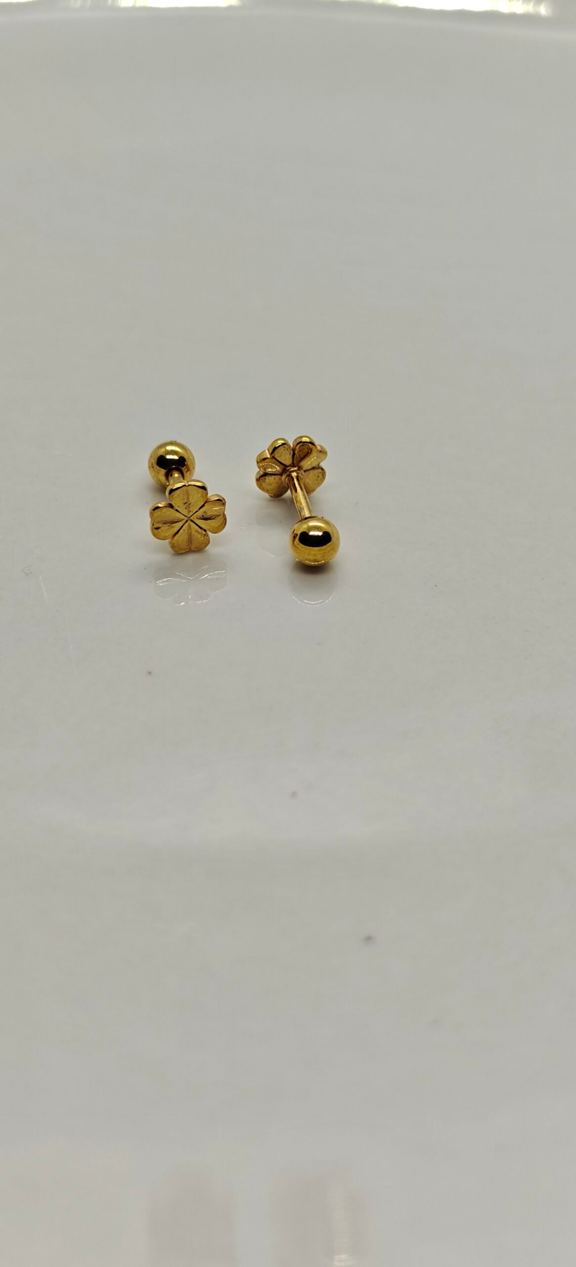 Gold flower screw back stainless steel gold plated earrings on white background