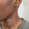 “Blue stainless steel star of David screwback stud earring worn on ear.”