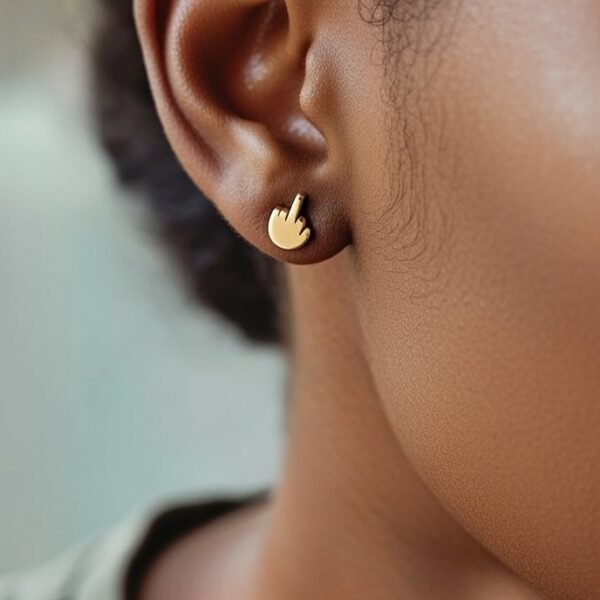 “Gold stainless steel hand screwback stud earring worn on ear.”