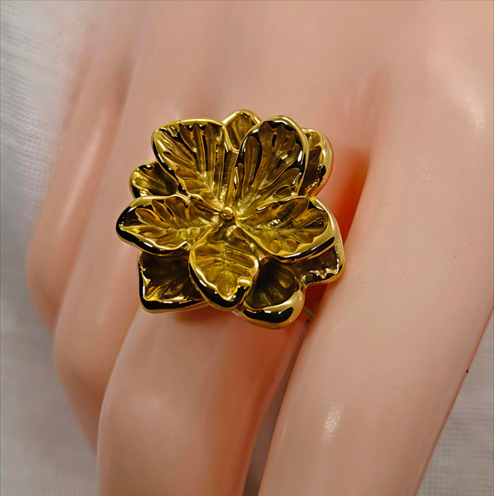 Elegant gold floral statement ring styled with women's fashion accessories