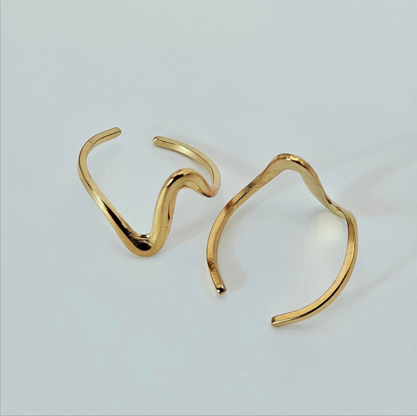 Size 10 HERDISE Aurelia Flow ring showing 304 stainless steel material and wave-inspired design