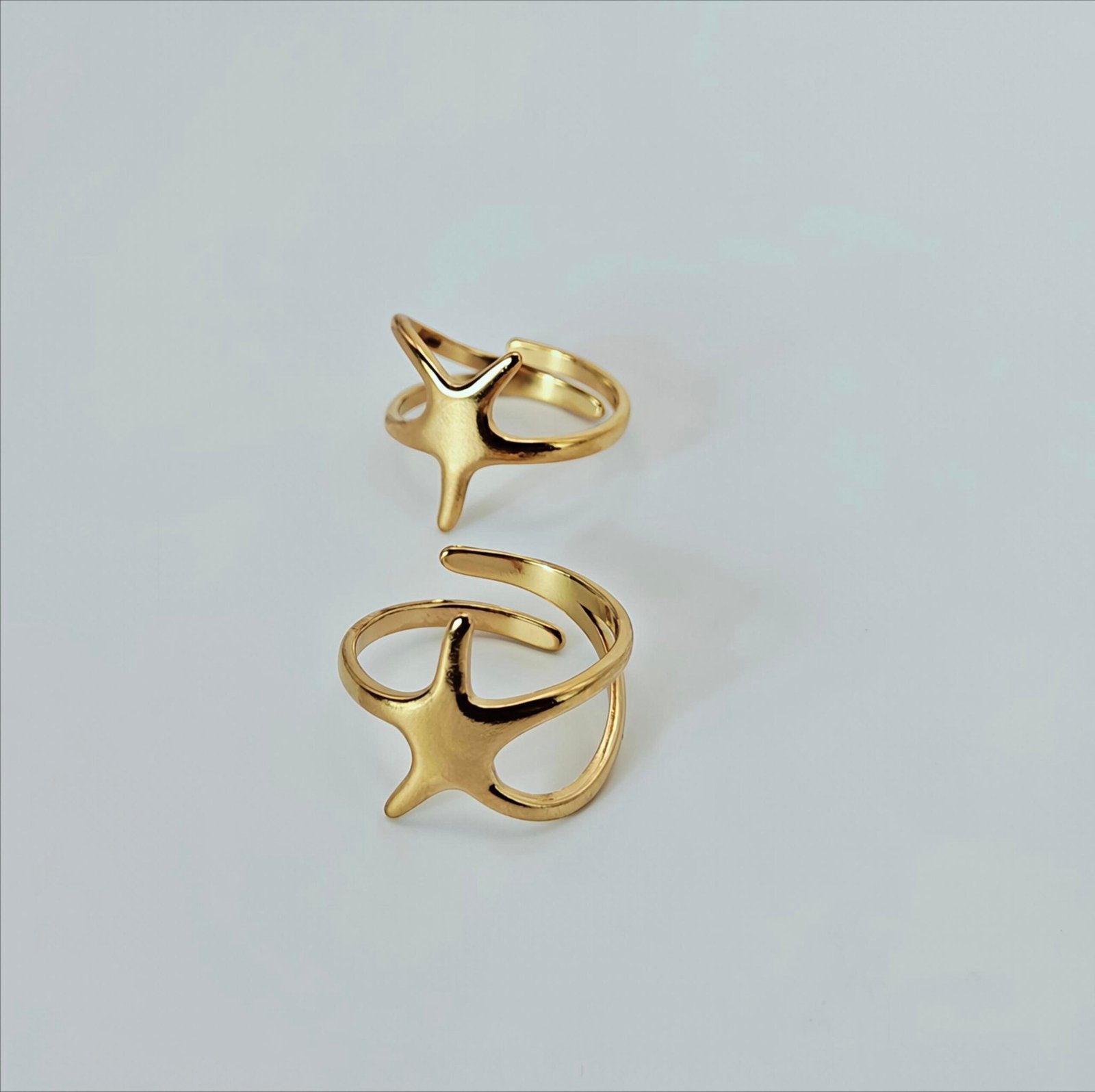 HERDISE Celestial Star gold-tone ring with sculpted four-point star and open-wrap band