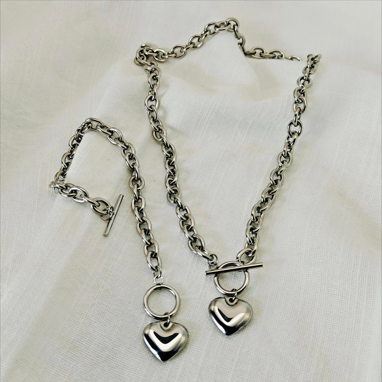 HERDISE silver-tone heart necklace and bracelet set featuring oval links and toggle clasps