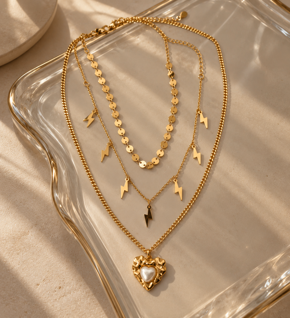 HERDISE gold-tone layered necklace with lightning bolt charms and textured heart pendant