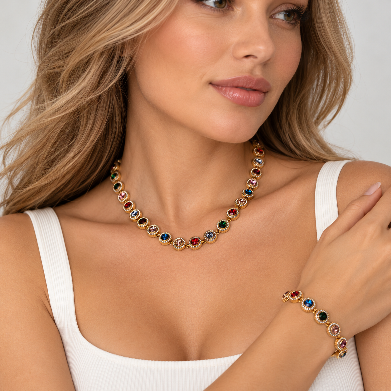 "Model wearing a gold-tone multicolor 16-inch necklace with round crystal-style accents from HERDISE."